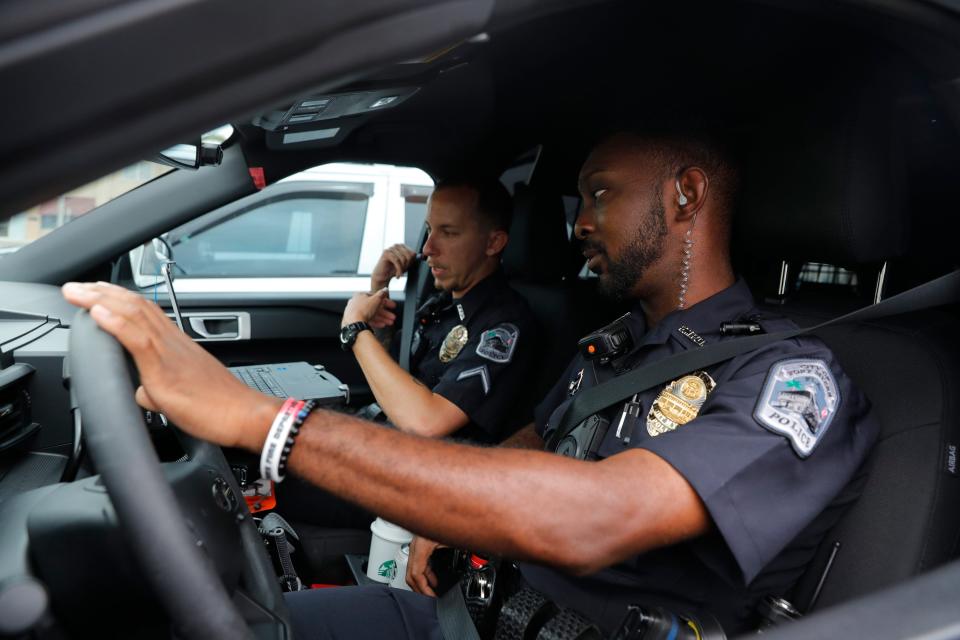 Members of the Fort Myers Police department, from right, Ian McMillion, officer in training, and Anthony Townsend, officer trainer, prepare to go on patrol on Friday, July 28, 2022.
