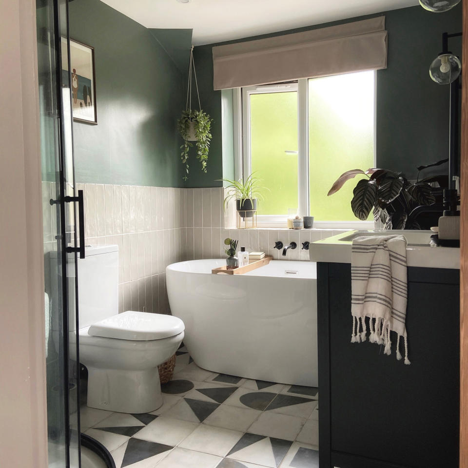 Contemporary bathroom with curved shower cubicle and black and white floor tiles