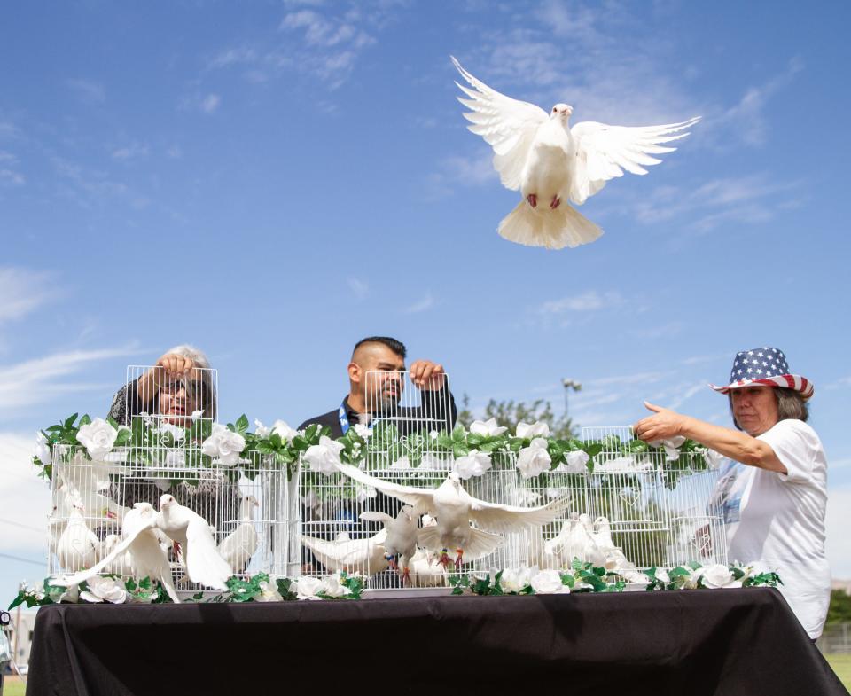 At far right, Pat Benavides helps open a cage to release doves during a remembrance held by Border Network for Human Rights on Aug. 3, 2023, for the fourth anniversary of the Aug. 3, 2019 mass shooting that took place inside a Walmart in El Paso, Texas.