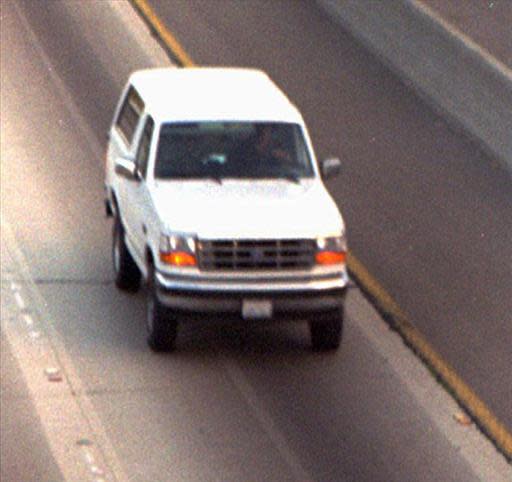White Ford Bronco driven by Al “A.C.” Cowlings and carrying O.J. Simpson trailed by police cars on freeway, California, photo. (AP)