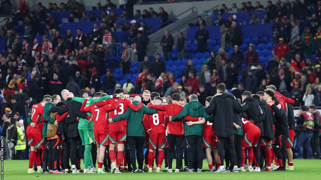 Wales players in a huddle after losing to Poland