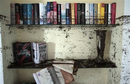 Dirtied books are seen in a flooded house following extreme rainfall in Olbia on Sardinia island November 20, 2013. REUTERS/Tony Gentile