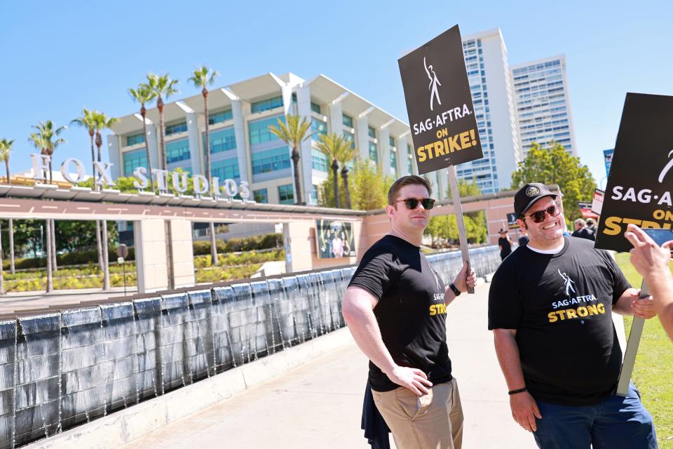 Rory O'Malley and Josh Gad join SAG-AFTRA and WGA members as they walk the picket line outside Fox Studios on July 14, 2023 in Los Angeles, California.