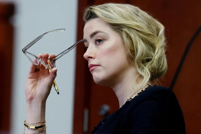 Amber Heard watches on during the defamation trial at the Fairfax County Circuit Court in Fairfax, Virginia, on April 28, 2022