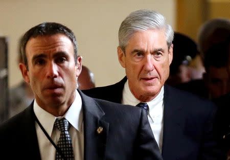 FILE PHOTO: Special Counsel Robert Mueller (R) departs after briefing members of the U.S. Senate on his investigation into potential collusion between Russia and the Trump campaign on Capitol Hill in Washington, U.S., June 21, 2017. REUTERS/Joshua Roberts