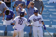 Los Angeles Dodgers' Justin Turner (10) is congratulated by Max Muncy (13) after hitting a solo home run in the sixth inning of a baseball game against the Washington Nationals, Friday, April 9, 2021, in Los Angeles. (AP Photo/Marcio Jose Sanchez)