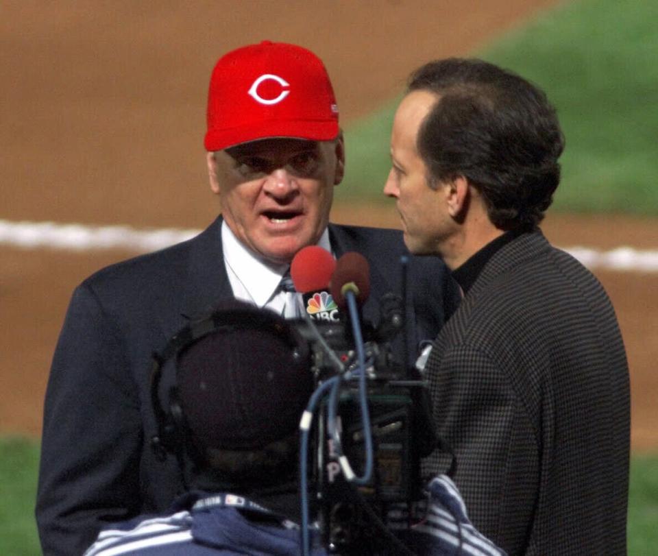 Pete Rose is interviewed by NBC's Jim Gray after the All-Century introductions before the second game of the 1999 World Series at Turner Field in Atlanta, Ga., Sunday Oct. 24, 1999.  NBC was deluged by complaints from fans in the hours after Gray's interview during Sunday's World Series pregame show. It centered on Rose's lifetime ban from the sport for gambling, and came minutes after Rose was announced as a member of baseball's All-Century team. (AP Photo/Mandatory Credit, Michael Schwarz) NO MAGS NOSALES