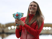 FILE - In this April 14, 2018, file photo, women's pole vault gold medalist Canada's Alysha Newman stands on the podium at Carrara Stadium during the 2018 Commonwealth Games on the Gold Coast, Australia. Three of the leading women’s pole vaulters will take their turn to compete in the second edition of the Ultimate Garden Clash. Katerina Stefanidi of Greece, Katie Nageotte of the United States and Alysha Newman of Canada will participate in the event but won’t be competing in their backyards since they don’t have the equipment at home. They will instead be at nearby training facilities. (AP Photo/Mark Schiefelbein, File)