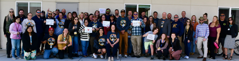 Arroyo Grande High School coach Phillip Reid is expected to run in the USA Olympic Marathon Team Trials in Orlando on Feb. 3, 2024. To help wish him good luck, Arroyo Grande High School staff bought “Team Reid” merchandise and gathered to cheer him before he left for the race. Courtesy of Lucia Mar Unified School District