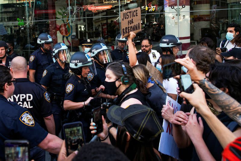 FILE PHOTO: Demonstrators scuffle with NYPD police officers as they try to march trough Times Square during a protest against racial inequality in the aftermath of the death in Minneapolis police custody of George Floyd, in New York City, New York