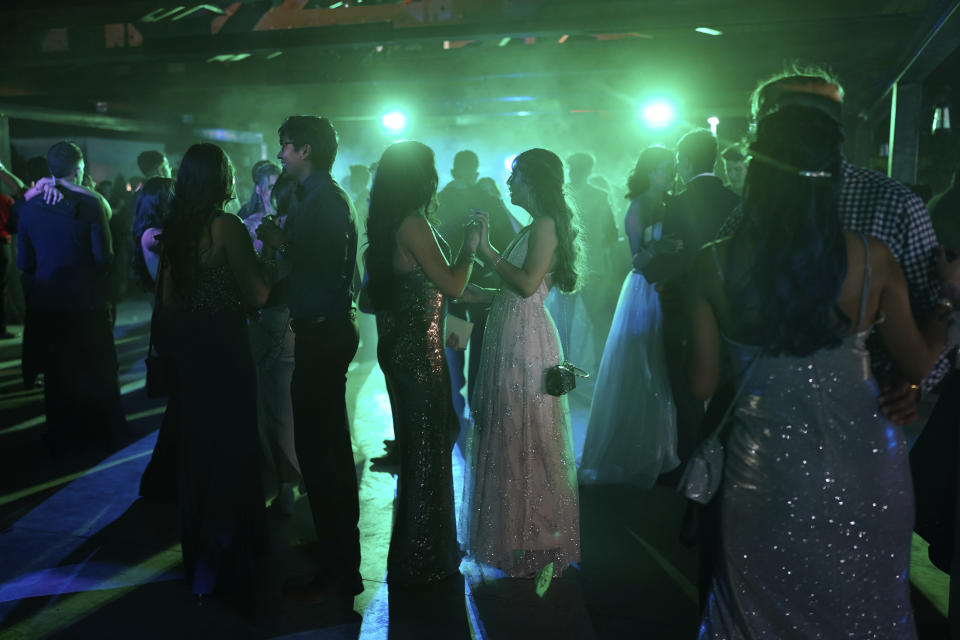 Young people dance during prom at the Grace Gardens Event Center in El Paso, Texas on Friday, May 7, 2021. Around 2,000 attended the outdoor event at the private venue after local school districts announced they would not host proms this year. Tickets cost $45. (AP Photo/Paul Ratje)