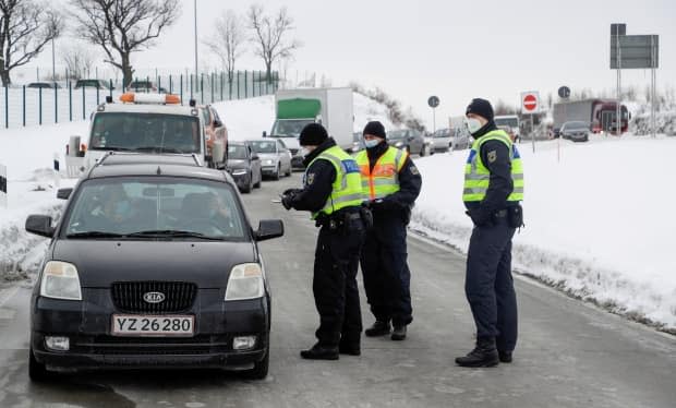 Police officers near Breitenau, Germany, check vehicles at the border with the Czech Republic on Feb. 15, following the introduction of restrictions by Germany due to the coronavirus pandemic.