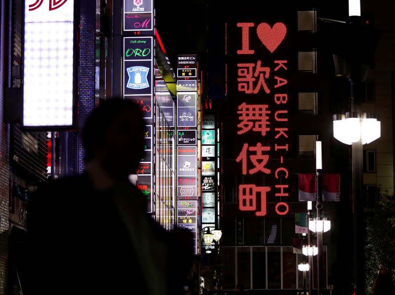 A passerby is seen in Kabukicho nightlife district, during a state of emergency to fight the coronavirus disease outbreak, in Tokyo