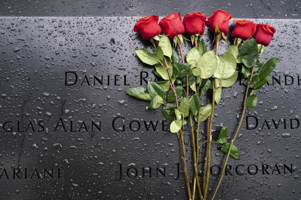 Red roses rest against the names of the fallen on the south pool at the National September 11 Memorial & Museum, Thursday, Sept. 9, 2021, in New York. (AP Photo/John Minchillo)