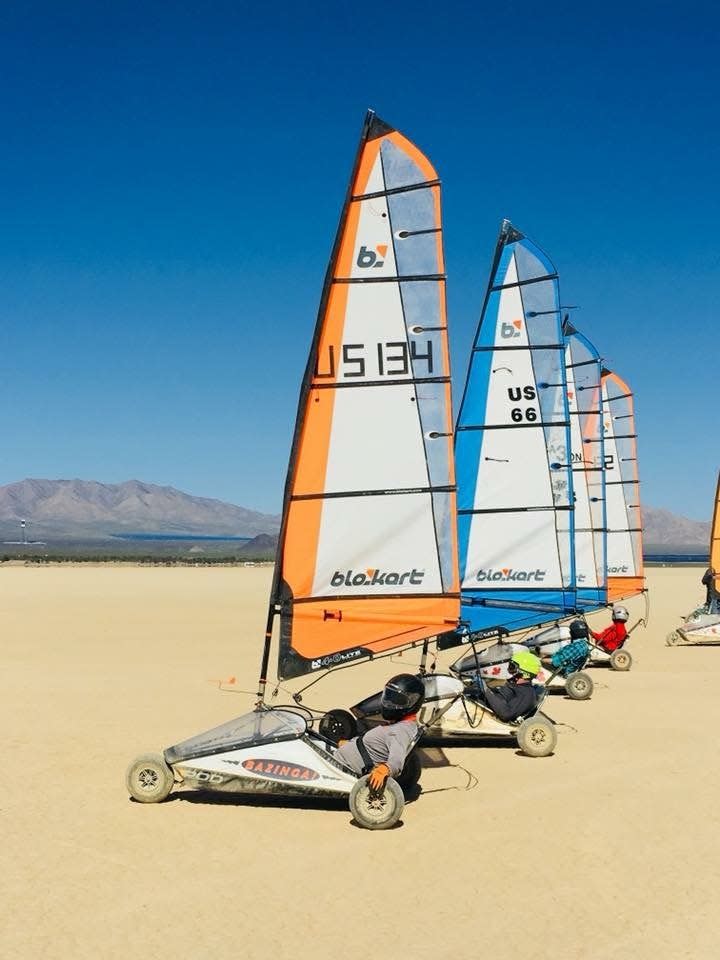 Blokarts line up at the starting line of a land sailing event at Lake Ivanpah in Mojave Desert in California.