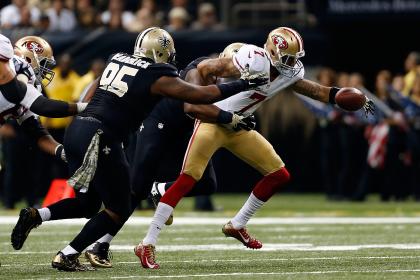 The Saints sacked Colin Kaepernick four times on Sunday. (Getty Images) 