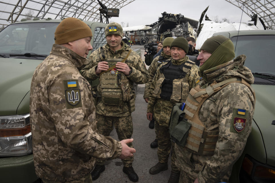 Commander of the Joint Forces of the Armed Forces of Ukraine Serhiy Nayev, left, talks to soldiers of mobile air defence units at the Antonov airport in Hostomel, on the outskirts of Kyiv, Ukraine, Saturday, April 1, 2023. (AP Photo/Efrem Lukatsky)