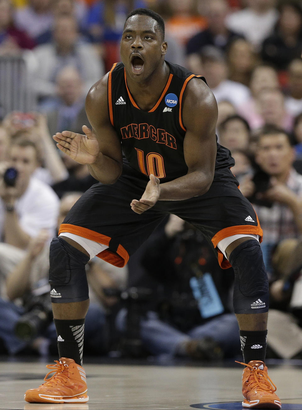 Mercer guard Ike Nwamu (10) celebrates during the first half of an NCAA college basketball second-round game against Duke, Friday, March 21, 2014, in Raleigh, N.C. (AP Photo/Chuck Burton)