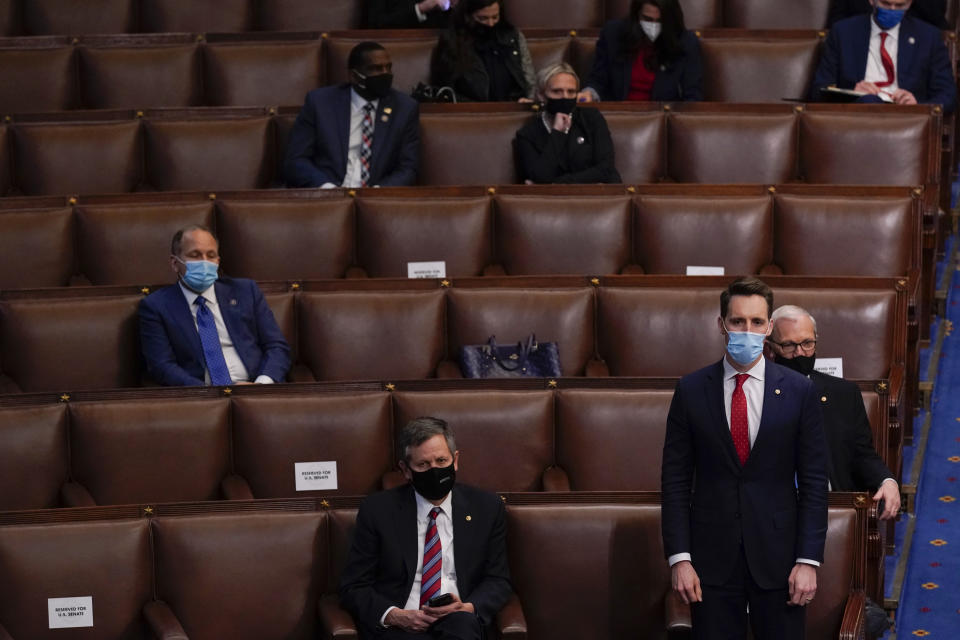 Sen. Josh Hawley, R-Mo., rises to join House Republican members to object to confirming the Electoral College votes from Pennsylvania during a joint session of the House and Senate to confirm the Electoral College votes cast in November's election, at the Capitol, early Thursday, Jan 7, 2021, in Washington. (AP Photo/Andrew Harnik)