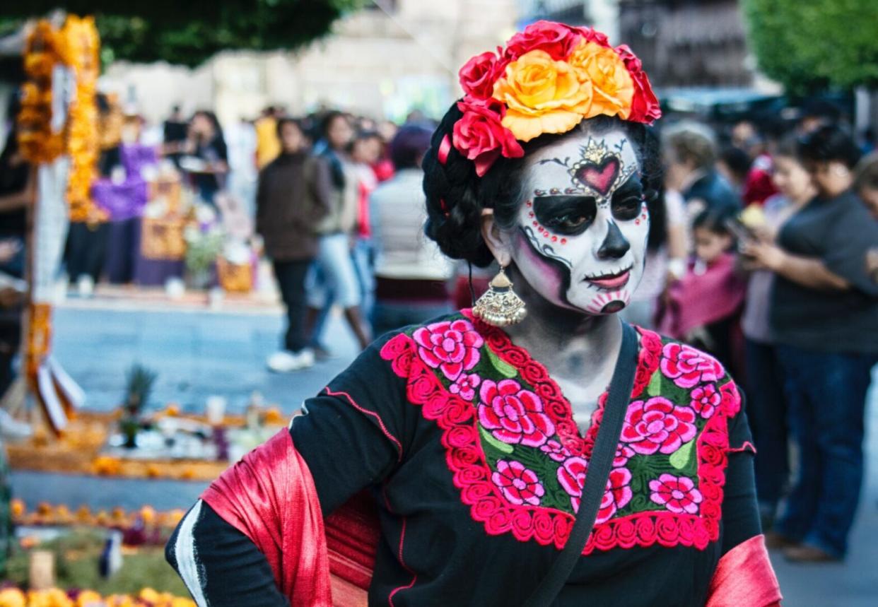 person in dia de los muertos face painting