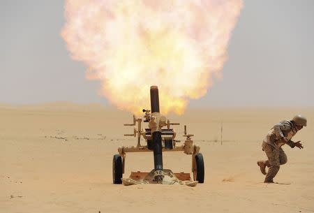 A Saudi soldier fires a mortar towards Houthi movement position, at the Saudi border with Yemen April 21, 2015. REUTERS/Stringer