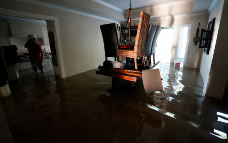 A family that wanted to remain anonymous moves belongings from their home flooded by Harvey in Houston, Texas August 31, 2017. REUTERS/Rick Wilking