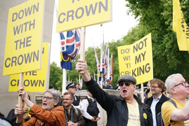 Anti-monarchy protesters hold up placards on The Mall with slogans such as 'down with the crown' and 'noy my King'