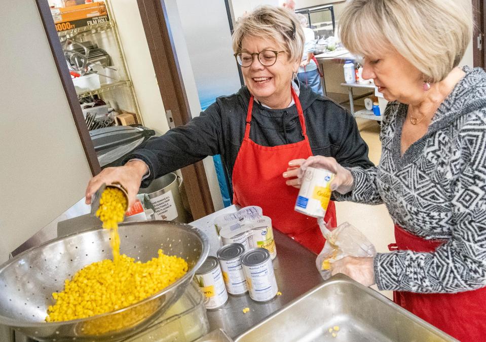 Angie Ross, left, and Dana Lutz prepare corn in December 2019 for a meal at the Community Kitchen of Monroe County. Chef's Challenge annually raises funds for the organization.