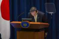 Japanese Prime Minister Yoshihide Suga bows during a press conference on Friday, April 23, 2021 in Tokyo, Japan. Japan has issued a third state of emergency for Tokyo and three western prefectures to curb a surge in the coronavirus just three months ahead of the Olympics. (Yuichi Yamazaki/Pool Photo via AP)