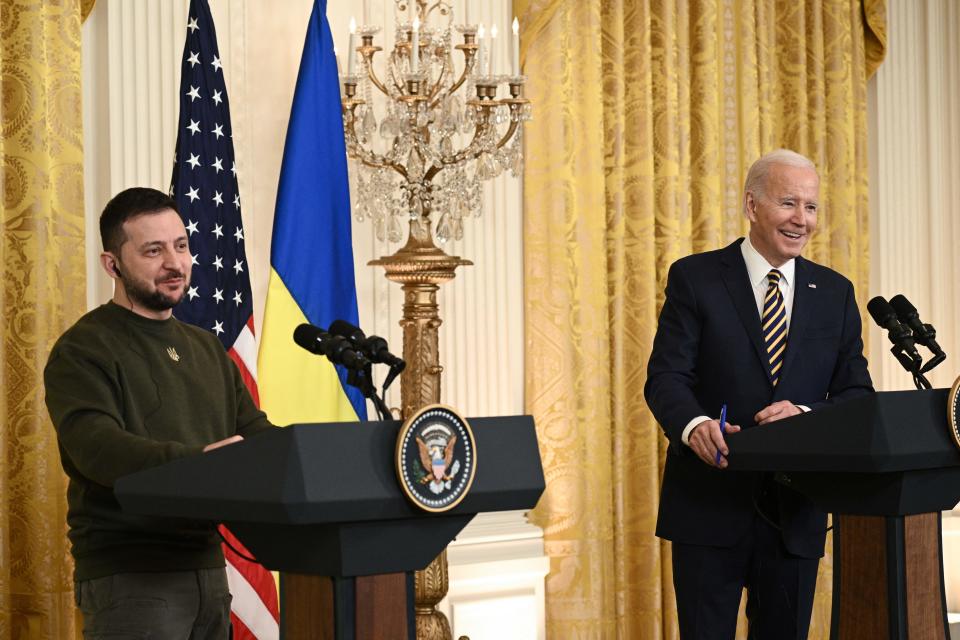 US President Joe Biden and Ukraine's President Volodymyr Zelensky hold a press conference in the East Room of the White House in Washington, DC, on December 21, 2022. - US President Joe Biden told Ukrainian leader Volodymyr Zelensky after a meeting at the White House on Wednesday that Ukraine will 