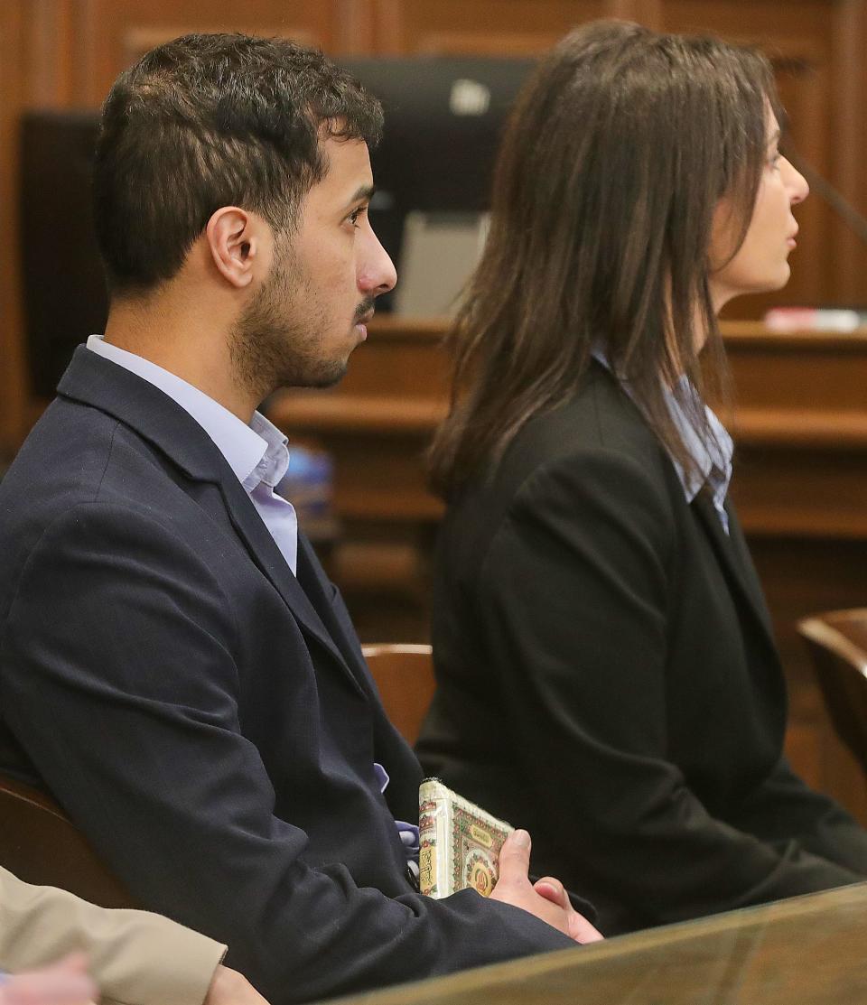 Mohamed Reeda clutches the Quran as he waits for a jury verdict with his defense lawyer Linda Malek on Monday.