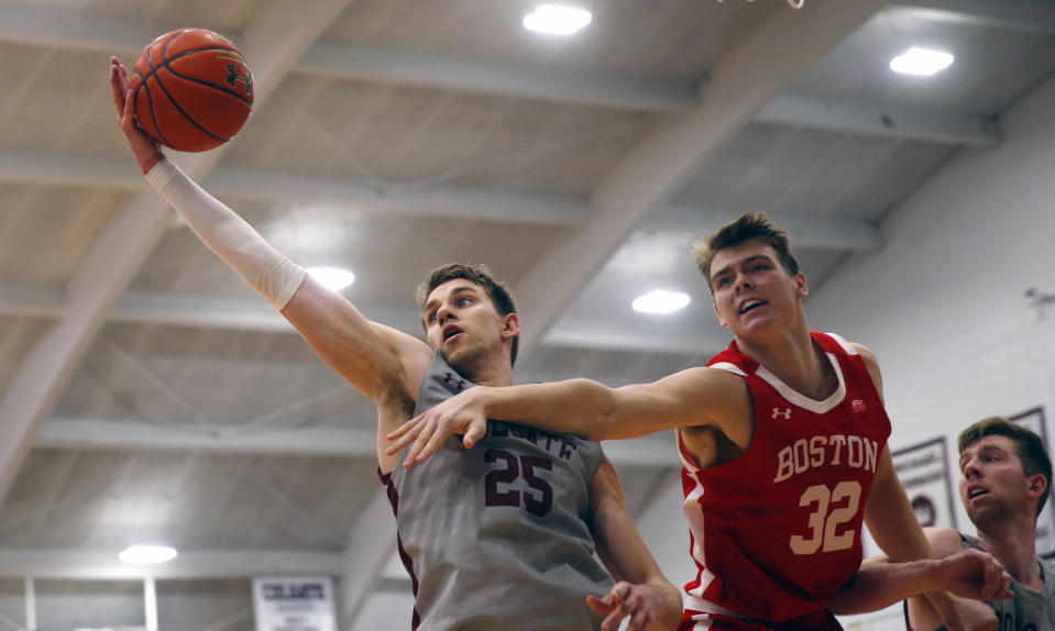 Colgate's Rapolas Ivanauskas (25) grabs a rebound from Boston University's Jack Hemphill (32) during the first half of the NCAA Patriot League Conference college basketball championship at Cotterell Court, Wednesday, March 11, 2020, in Hamilton, N.Y. (AP Photo/John Munson)