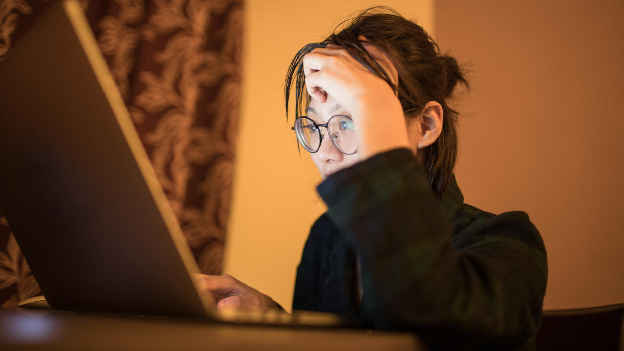 female college students using laptop late at night in search for information online.