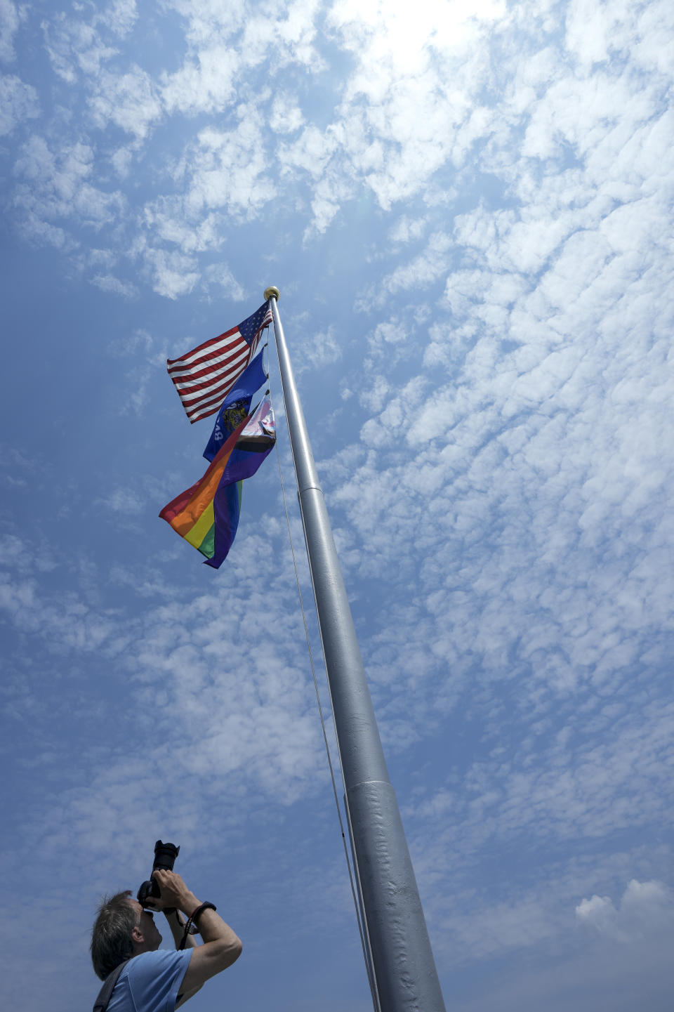 Wisconsin State Journal photographer John Hart takes pictures of the Pride Flag at the Wisconsin State Capitol, Thursday, June 1, 2023, in Madison, Wis. (AP Photo/Morry Gash)