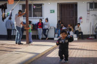 In this Jan. 28, 2020 photo provided by Cronkite News, Arizona State University, migrant families wait at Casa del Migrante before they receive shots and medical care in San Luis Rio Colorado, Mexico. One Hundred Angels, a Phoenix organization that provides medical care and other services to migrants, helped coordinate the one-day vaccination clinic at Casa del Migrante, working with the Mexican Red Cross. (Delia Johnson/Cronkite News, Arizona State University via AP)