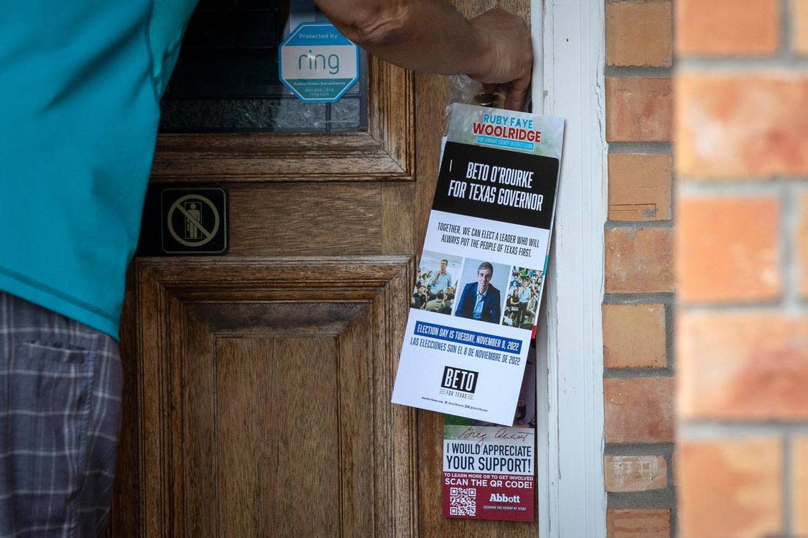 Amjad Bhular leaves campaign flyers for Democratic candidates at the home of someone visited by the opposing campaign in Grand Prairie, Texas, on Wednesday, Oct. 5, 2022.