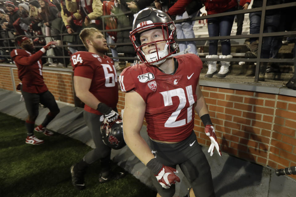 FILE - In this Nov. 23, 2019, file photo Washington State running back Max Borghi (21) celebrates with fans after Washington State defeated Oregon State 54-53 in an NCAA college football game in Pullman, Wash. Borghi is likely to get more rushing attempts under the new Washington coach Nick Rolovich. Borghi was an All-Pac-12 honorable mention last season after recording 1,435 all-purpose yards and 16 total touchdowns, second-most in the league. (AP Photo/Ted S. Warren,File)