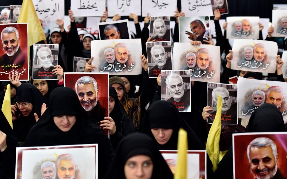 Supporters of Hezbollah carry pictures of Qasem Soleimani, the commander of the Quds Force, and Abu Mahdi al-Muhandis, the Iraqi militia commander