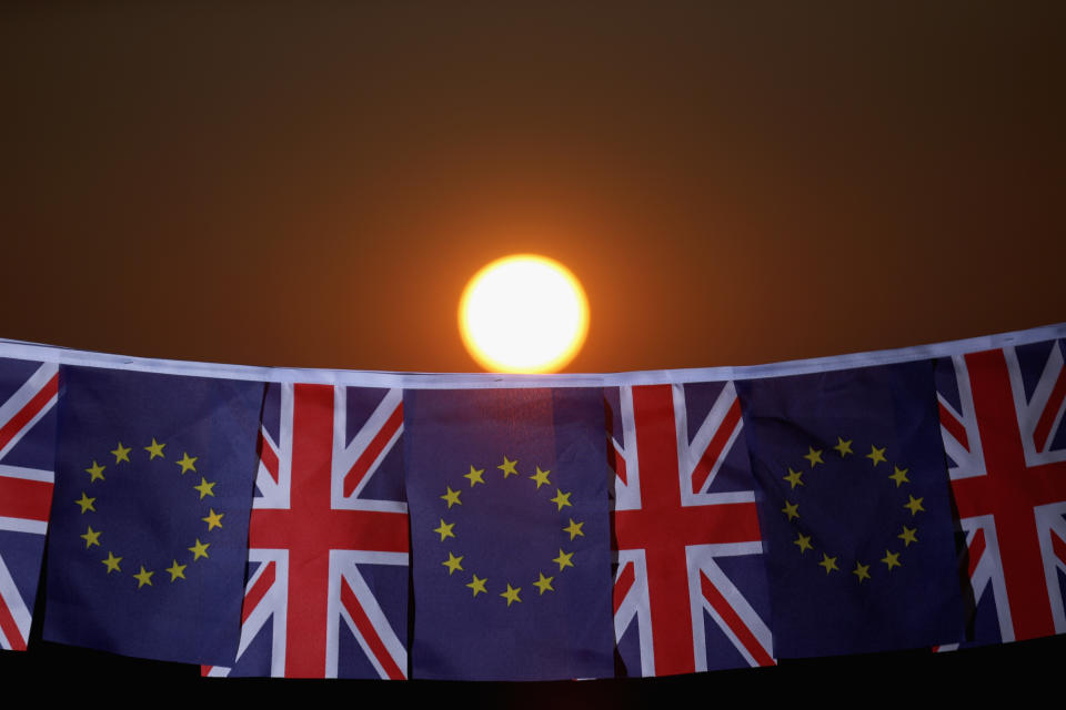KNUTSFORD, UNITED KINGDOM - MARCH 17:  In this photo illustration, the sun sets behind European Union and the Union flag bunting on March 17, 2016 in Knutsford, United Kingdom. The United Kingdom will hold a referendum on June 23, 2016 to decide whether or not to remain a member of the European Union (EU), an economic and political partnership involving 28 European countries which allows members to trade together in a single market and free movement across its borders for citizens.  (Photo illustration by Christopher Furlong/Getty Images)