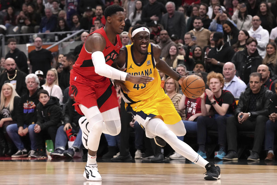 Indiana Pacers' Pascal Siakam, right, drives past Toronto Raptors' RJ Barrett during the second half of an NBA basketball game Wednesday, Feb. 14, 2024, in Toronto. (Chris Young/The Canadian Press via AP)