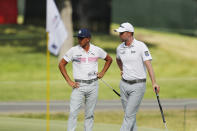 Rickie Fowler, left, talks with Webb Simpson on the 18th green during the second round of the Rocket Mortgage Classic golf tournament, Friday, July 3, 2020, at the Detroit Golf Club in Detroit. (AP Photo/Carlos Osorio)