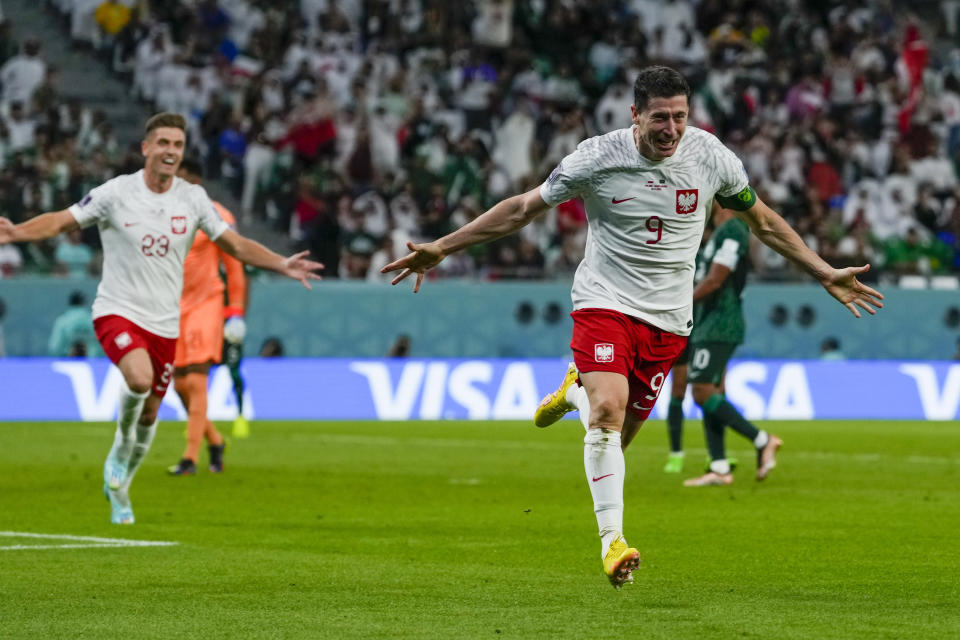 Poland's Robert Lewandowski celebrates scoring his side's 2nd goal during the World Cup group C soccer match between Poland and Saudi Arabia, at the Education City Stadium in Al Rayyan , Qatar, Saturday, Nov. 26, 2022. (AP Photo/Manu Fernandez)