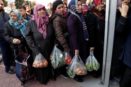 People wait in line to buy vegetables sold in a tent set up by the municipality in the Bayrampasa district of Istanbul, Turkey, February 11, 2019. REUTERS/Murad Sezer