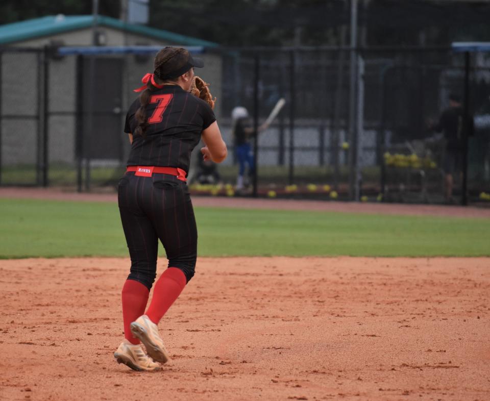Seminole Ridge's Grace Rawn completes a throw to first base for an out in the first inning of the Hawks' regular season game against palm Beach Gardens on Mar. 27, 2024.