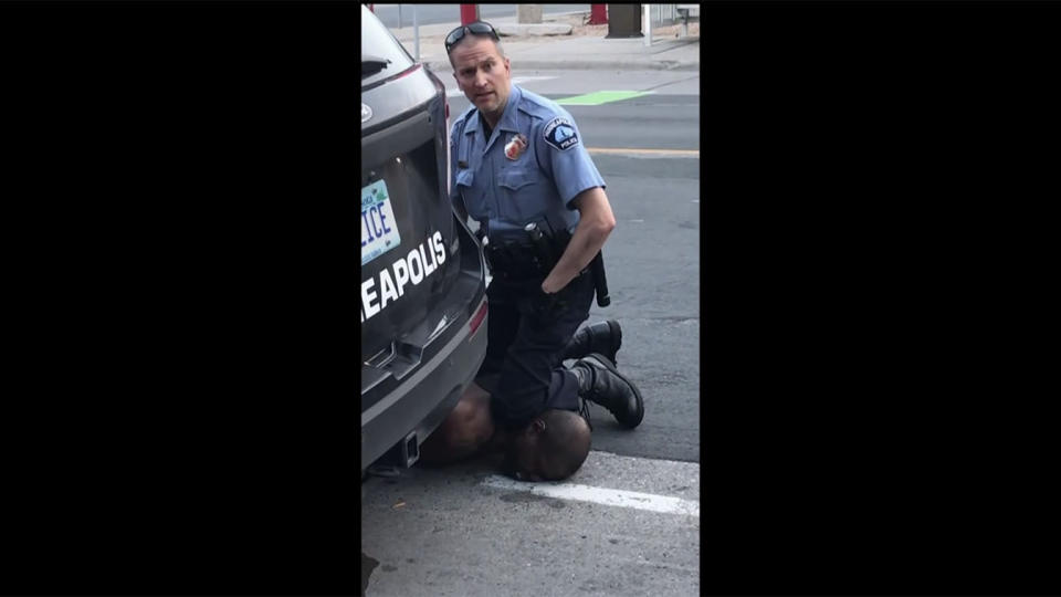 Derek Chauvin is seen with his knee on George Floyd's neck in video shown at the officer's trial Monday. (Screengrab via Yahoo News)