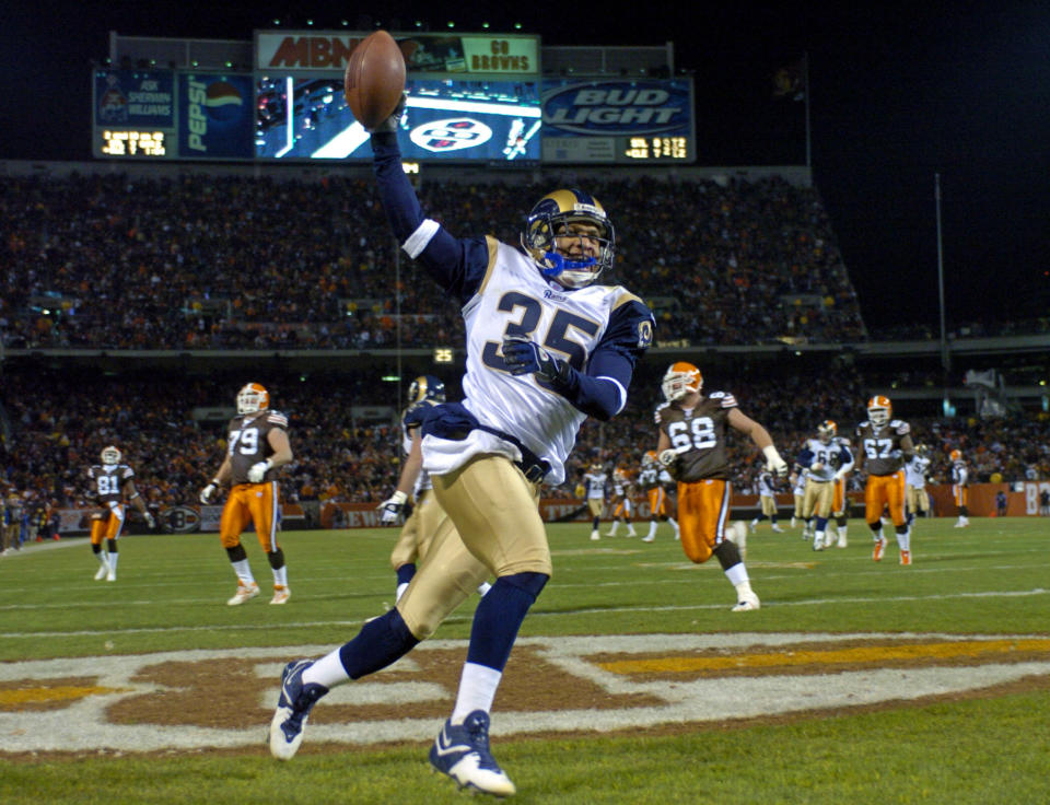 File-St. Louis Rams' Aeneas Williams celebrates after a 46-yard interception return for a touchdown against the Cleveland Browns Monday, Dec. 8, 2003, in Cleveland. After shutting down receivers during his Hall of Fame career, Williams is helping open doors for fellow NFL alums. Williams, the former Cardinals, and Rams defensive back hosts the NFL Legends podcast, a platform for former players to share their stories, encourage each other and learn about programs available to them. (AP Photo/Morry Gash, File)