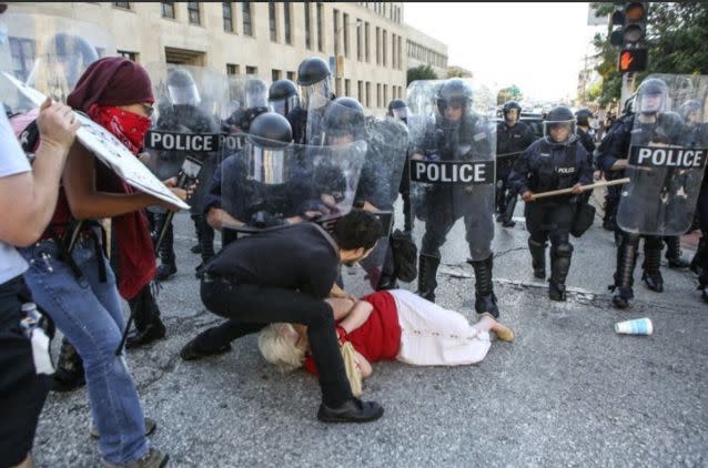 The woman was mowed down by the marching police force. Source: Reuters