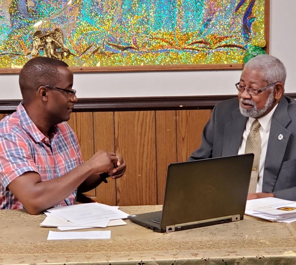 George Norman Jr., chairman of deacons at Progressive Missionary Baptist Church, talks with Wilson Majee, associate professor in the MU School of Health Professions.