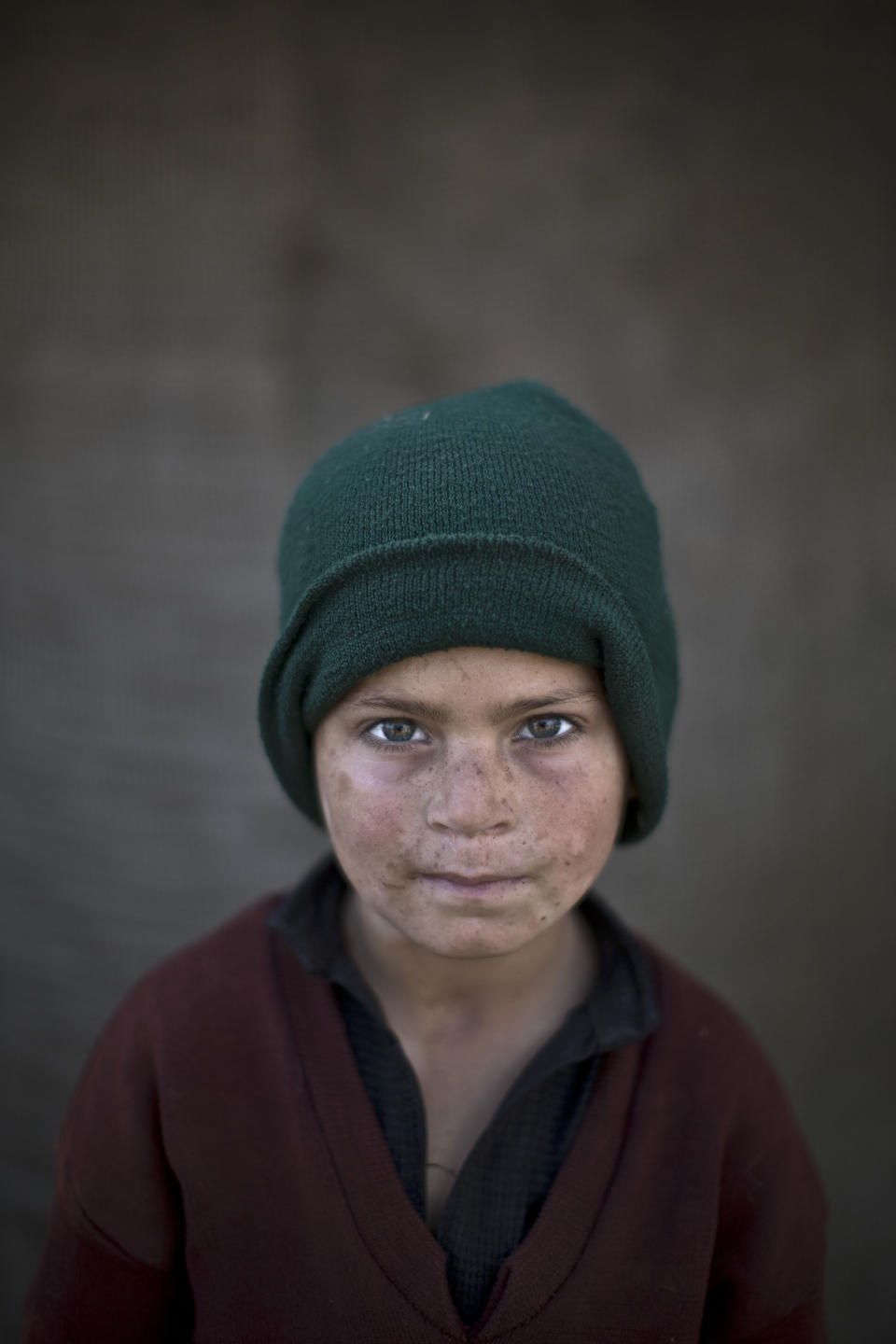 In this Sunday, Jan. 26, 2014 photo, Afghan refugee boy, Hazrat Babir , 7, poses for a picture, while playing with other children in a slum on the outskirts of Islamabad, Pakistan. For more than three decades, Pakistan has been home to one of the world’s largest refugee communities: hundreds of thousands of Afghans who have fled the repeated wars and fighting their country has undergone. Since the 2002 U.S.-led invasion of Afghanistan, some 3.8 million Afghans have returned to their home country, according to the U.N.’s refugee agency. (AP Photo/Muhammed Muheisen)