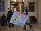 <p>A Democratic aide carries a chart past the Senate chamber to be used by the minority to argue against the Republican tax bill, on Capitol Hill in Washington, Friday night, Dec. 1, 2017. (Photo: J. Scott Applewhite/AP) </p>